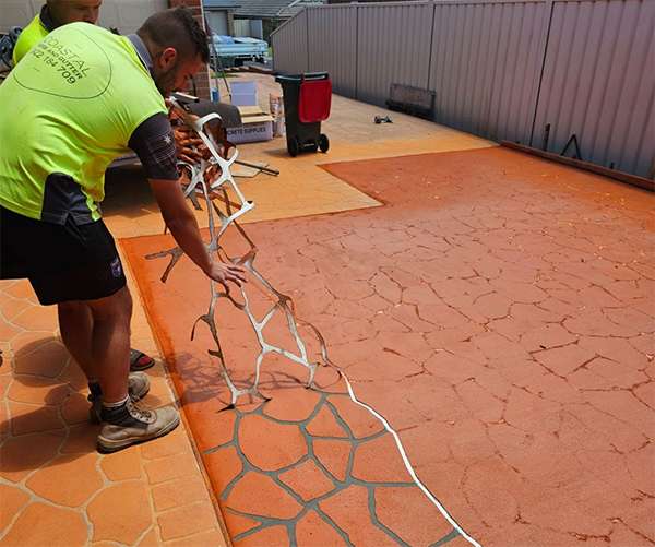 Coloured driveway being stenciled
