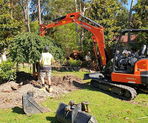 Digging in garden with excavator